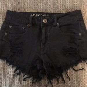 Black frayed and ripped American Eagle shorts.